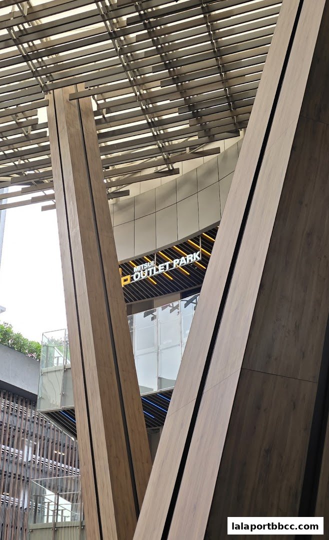 Modern architectural design with wooden pillars and the Mitsui Outlet Park logo visible.