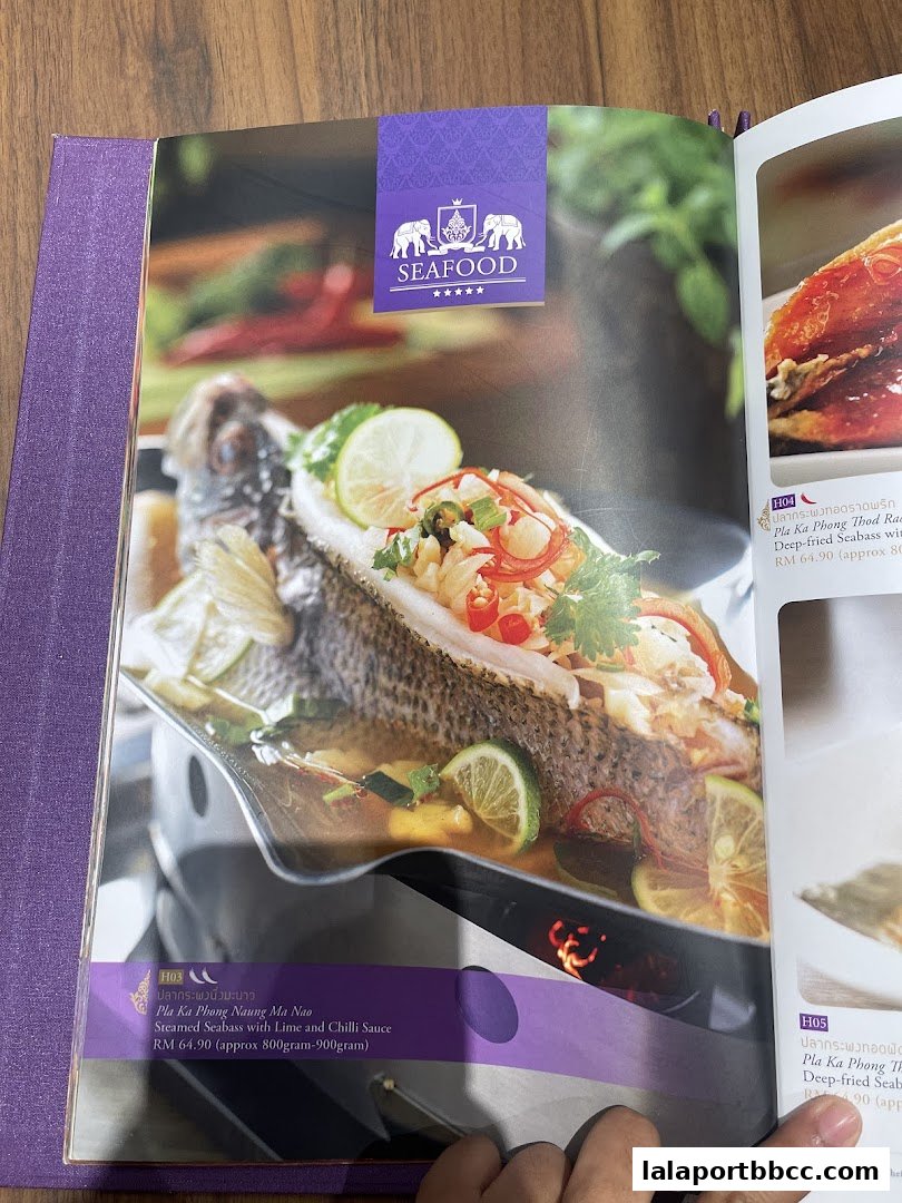 A menu page from ParaThai Lalaport BBCC featuring a steamed seabass dish.