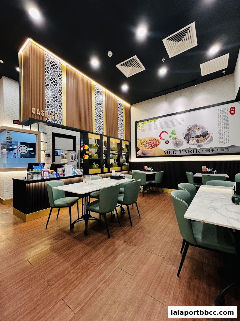 Interior view of a modern restaurant with elegant seating and decorative wall panels.
