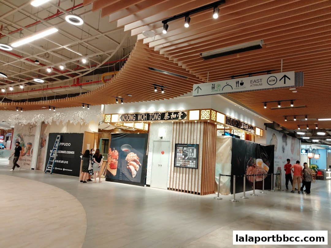 The Koong Woh Tong shop front in a modern shopping mall with signage and food displays.