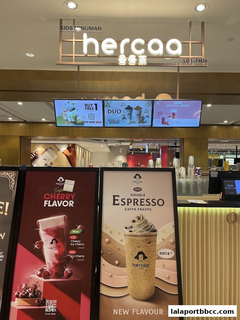A beverage shop called Hercaa with promotional displays for cherry and espresso drinks.