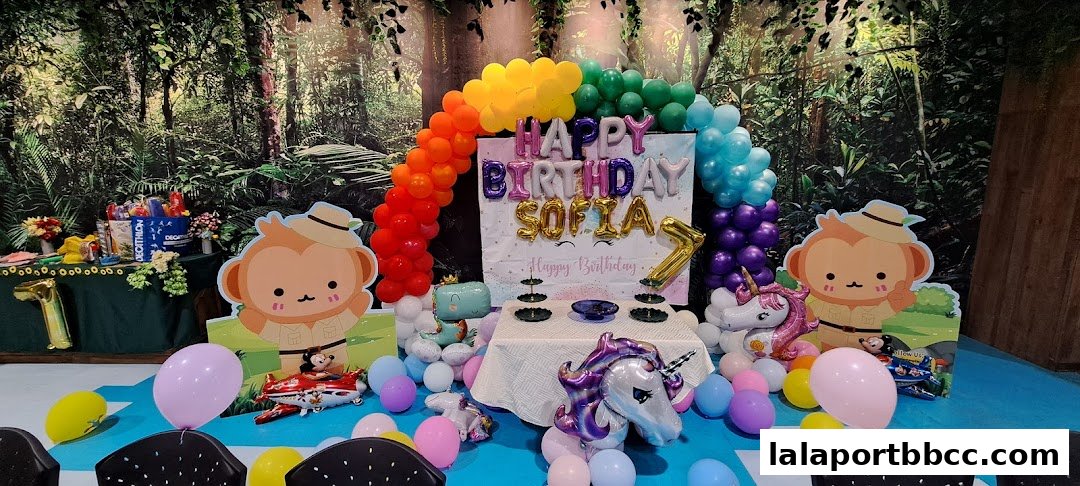 A jungle-themed birthday party setup with balloons, banners, and character cutouts.