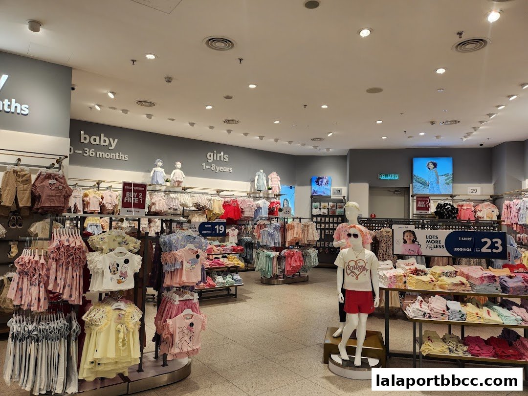 Interior view of a Babyshop store showcasing clothing for babies and girls, with mannequins and displays.