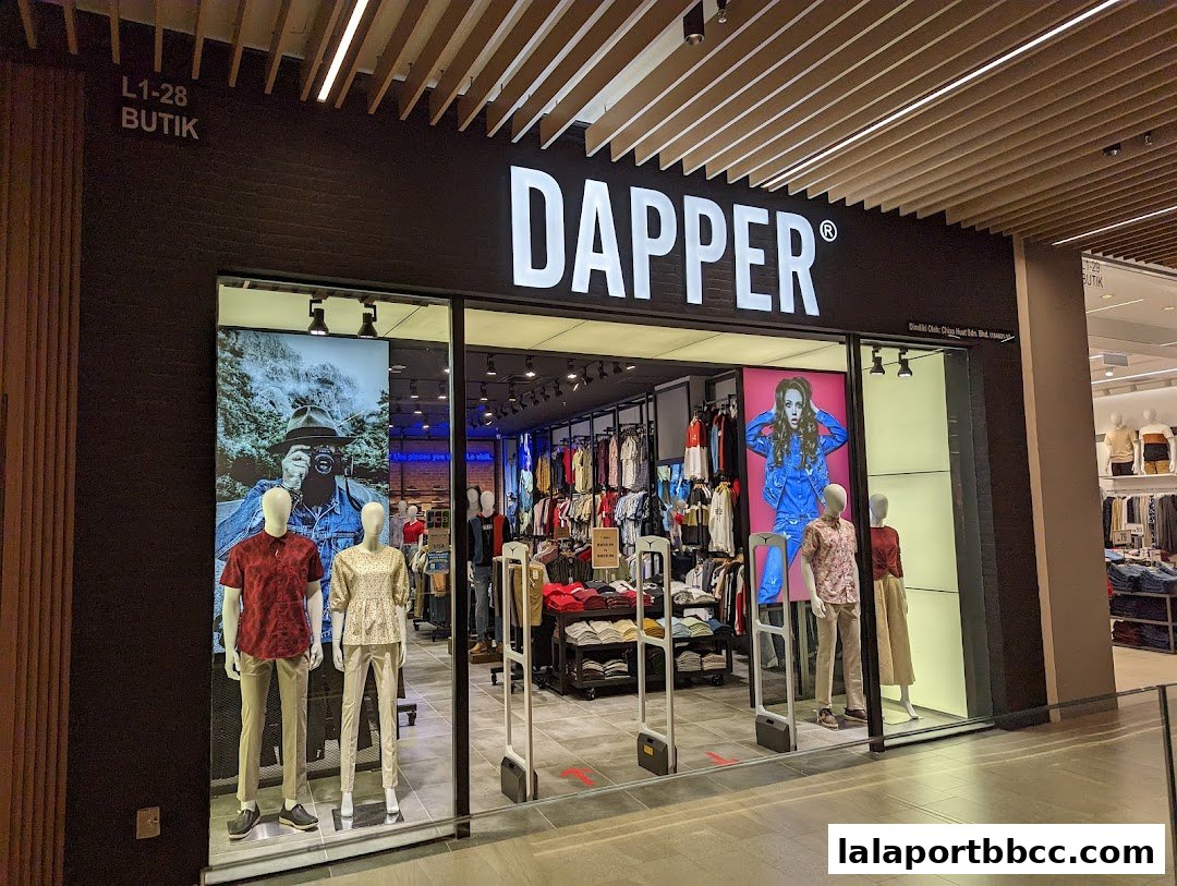 The Dapper clothing store features a modern storefront with mannequins displaying stylish outfits and a well-lit interior.