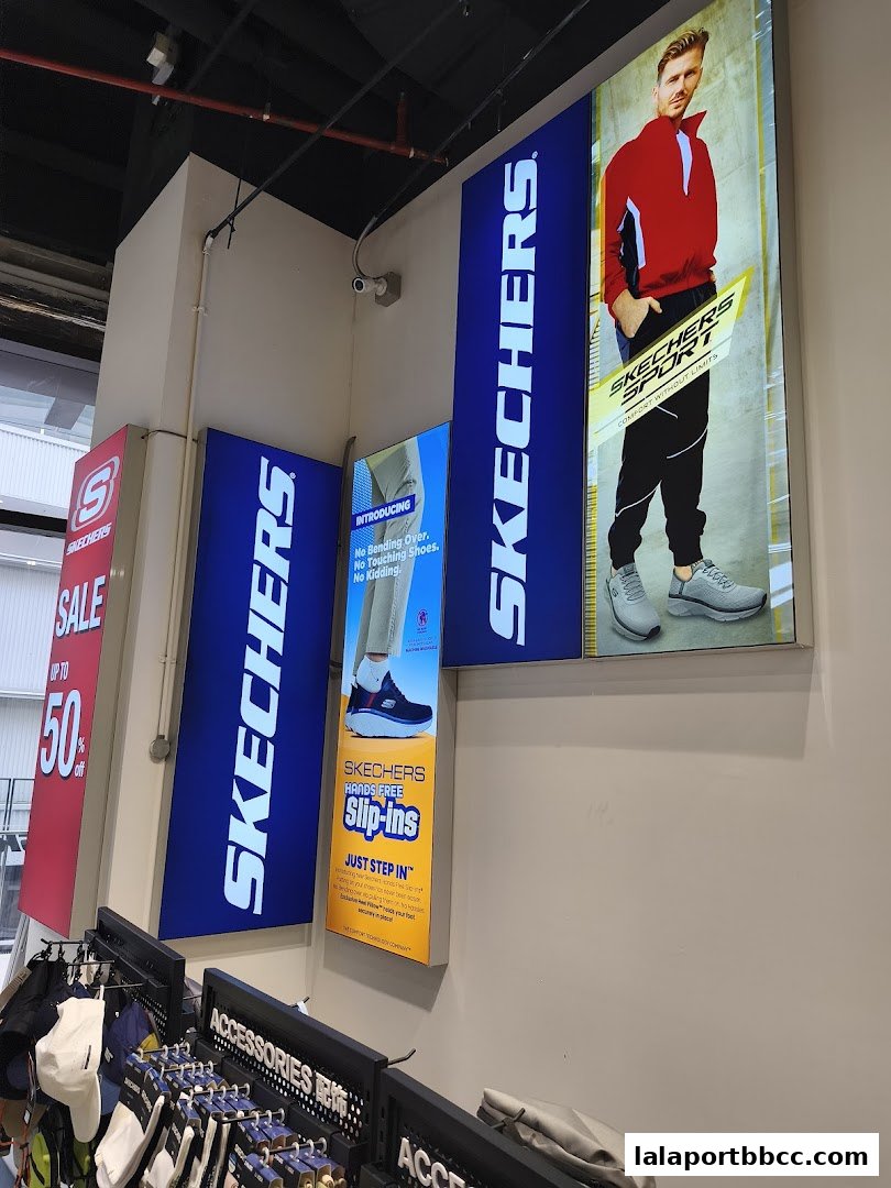 Skechers store interior with illuminated advertisements for shoes and accessories.