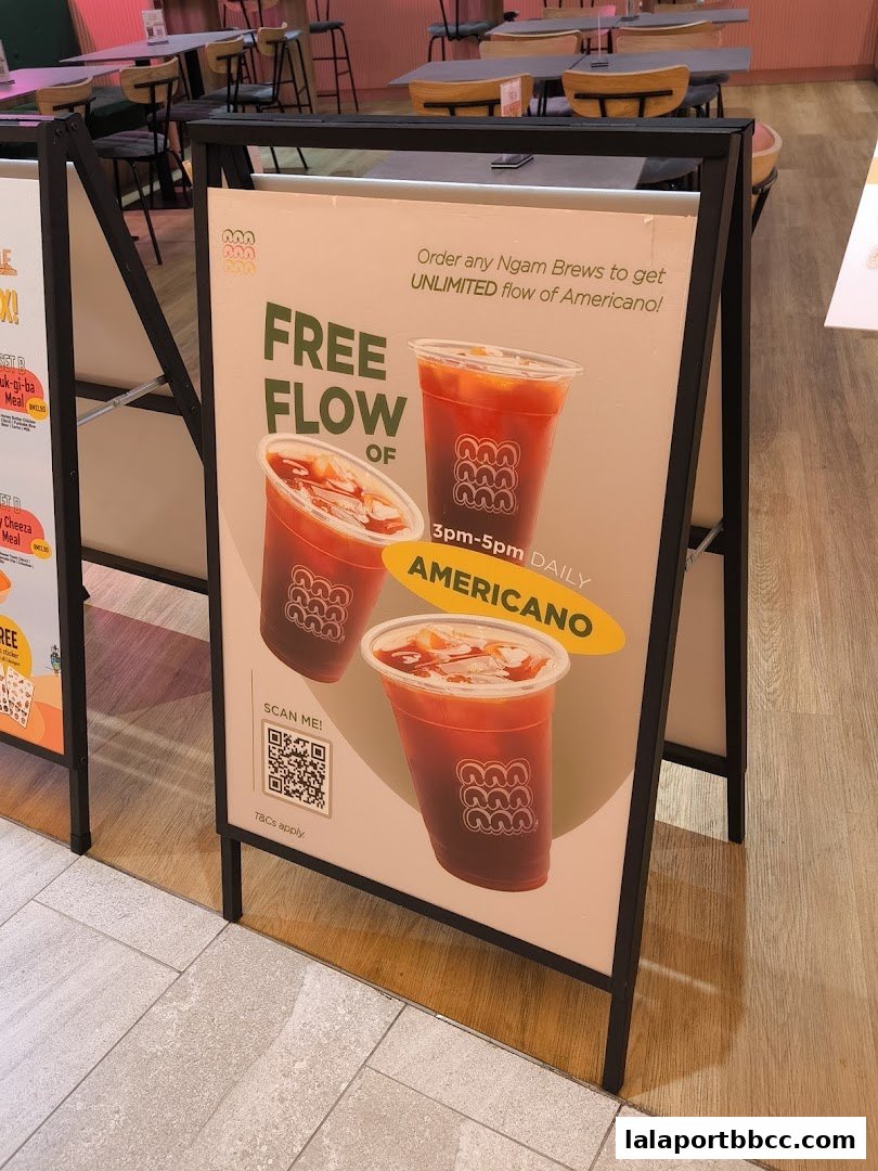 A-frame sign advertising a free flow Americano promotion at Ngam Ngam Neighbourhood.