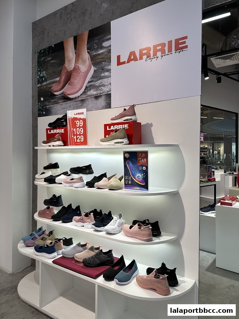 A well-lit shoe store display featuring various styles of Larrie brand sneakers on shelves.