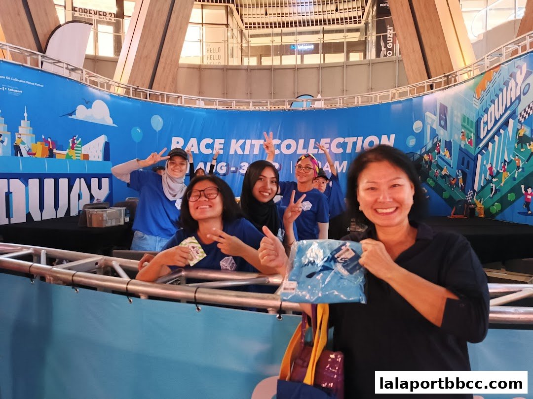 A group of people posing for a photo at a race kit collection event.
