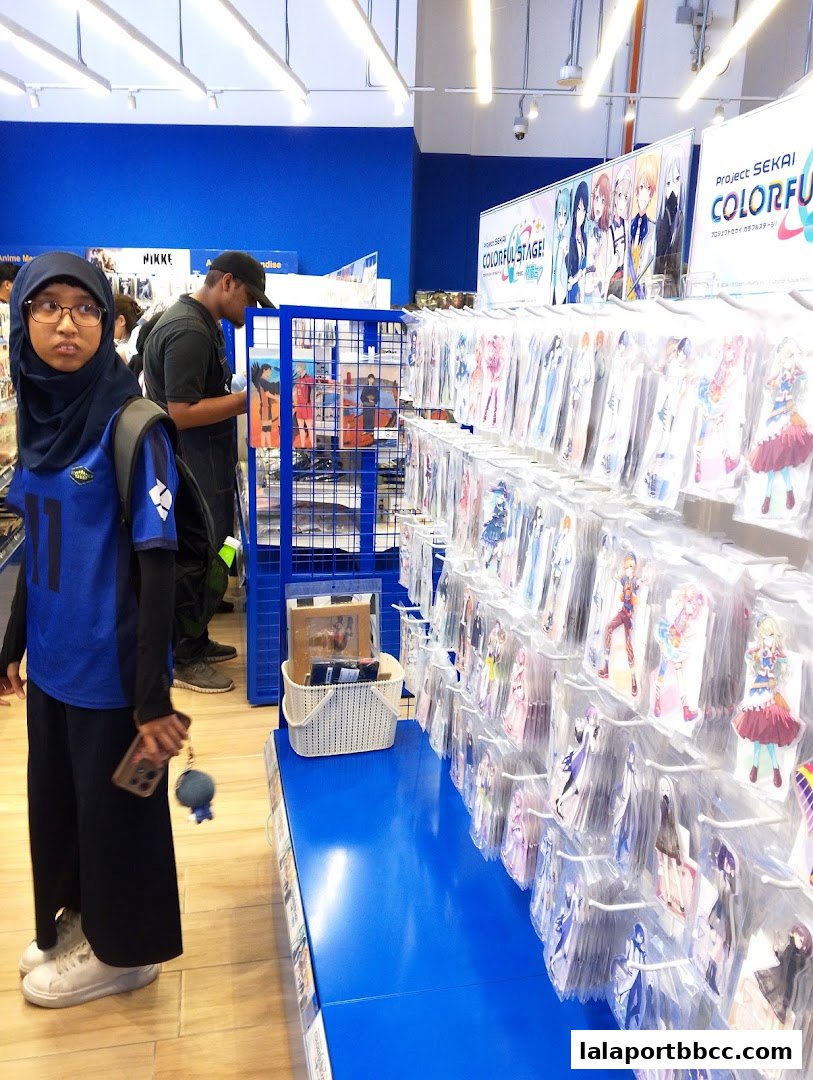 Animate store interior showcasing anime merchandise and a young woman browsing.