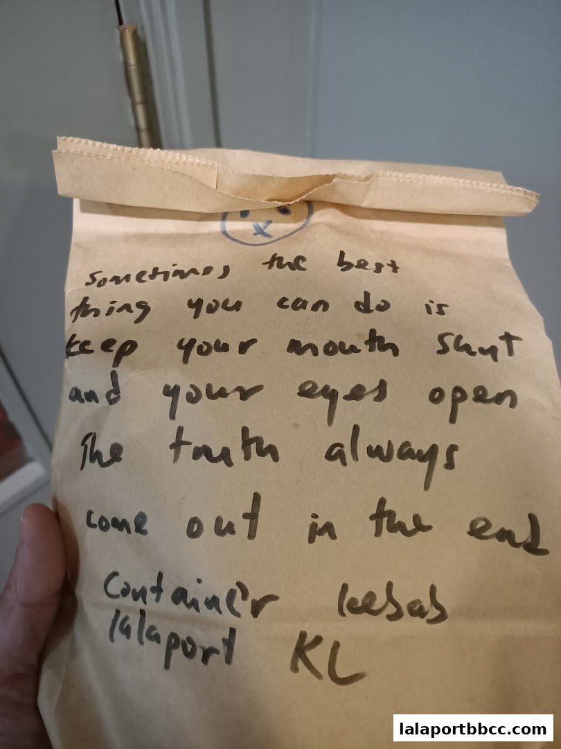 A brown paper bag with handwritten text and a smiley face.