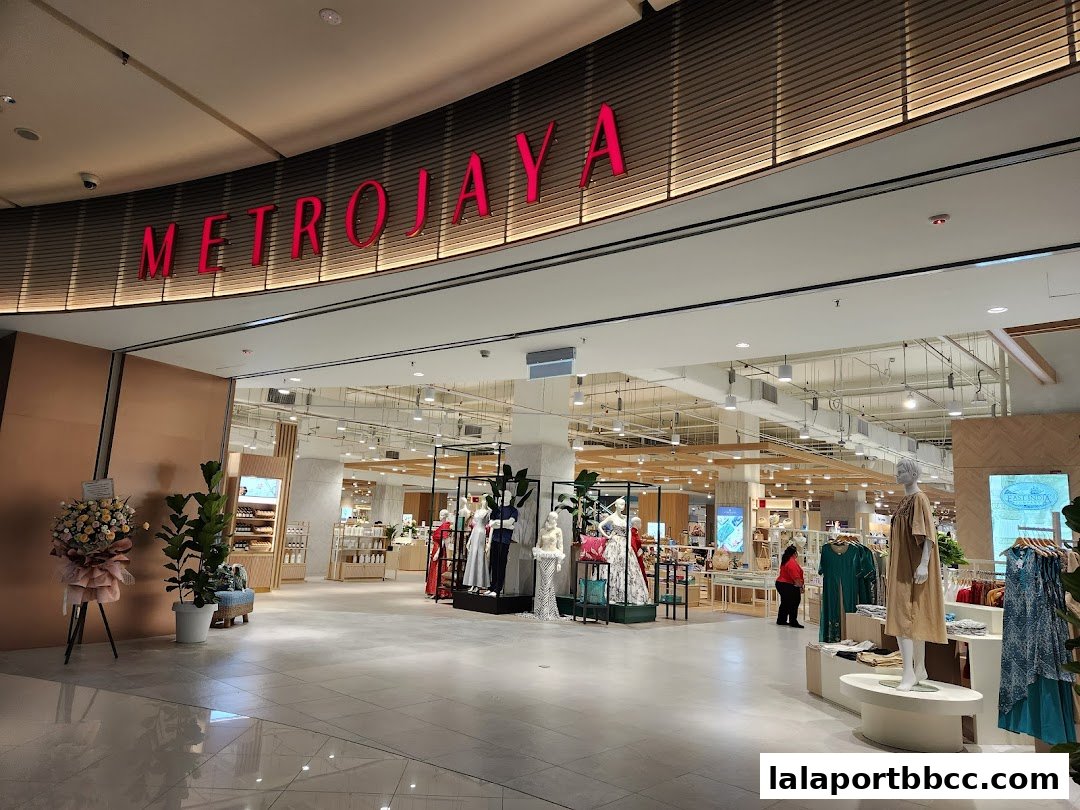 The entrance to Metrojaya department store, showcasing fashion displays and merchandise.