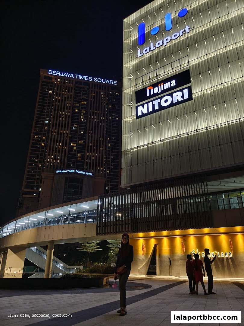 Night view of LaLaport shopping mall with Berjaya Times Square in the background.