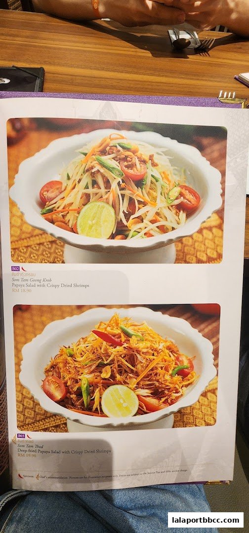 A menu page showcasing two vibrant papaya salad dishes with detailed descriptions and prices.