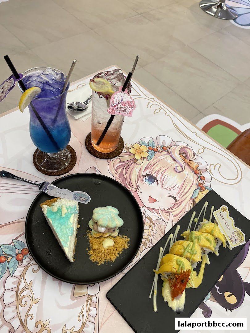 A table setting with two colorful drinks, a slice of cheesecake, and sushi rolls.