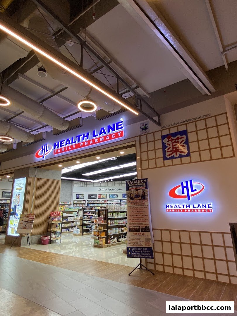 The entrance and interior of Health Lane Family Pharmacy, showcasing shelves stocked with health and beauty products.