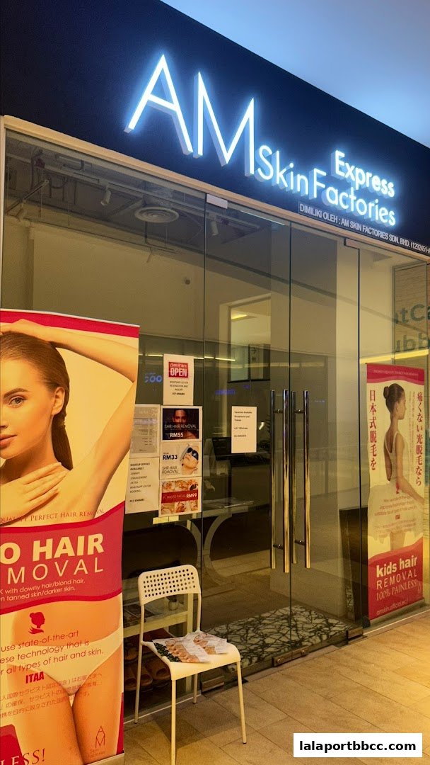 The entrance of AM Skin Factories Express, a beauty salon, with promotional posters and a chair outside.