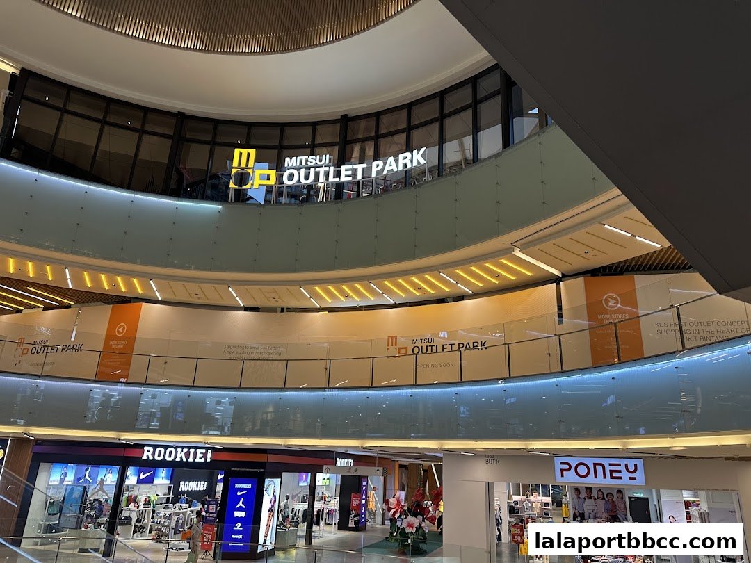 Interior view of Mitsui Outlet Park with various shops and signage.