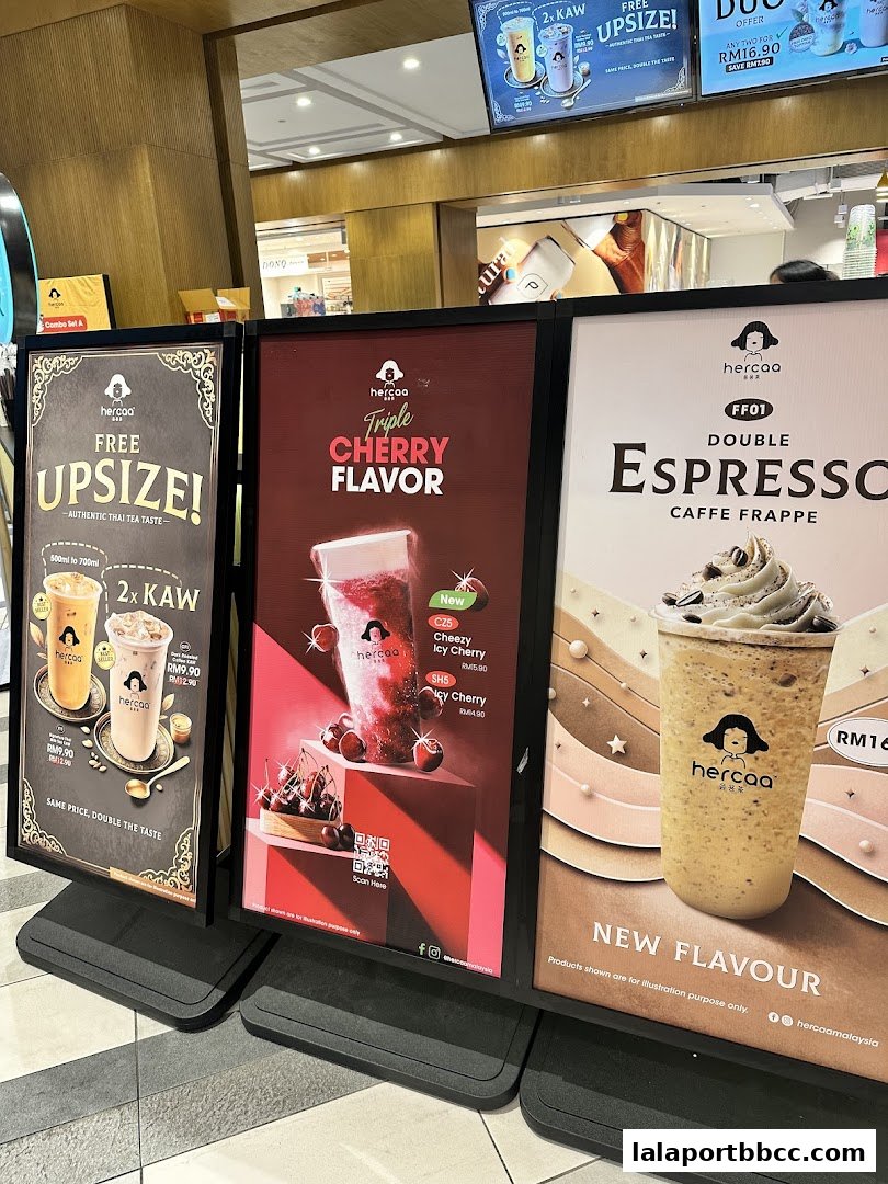 Three large display boards showcasing drinks from Hercaa, featuring promotions and new flavors.