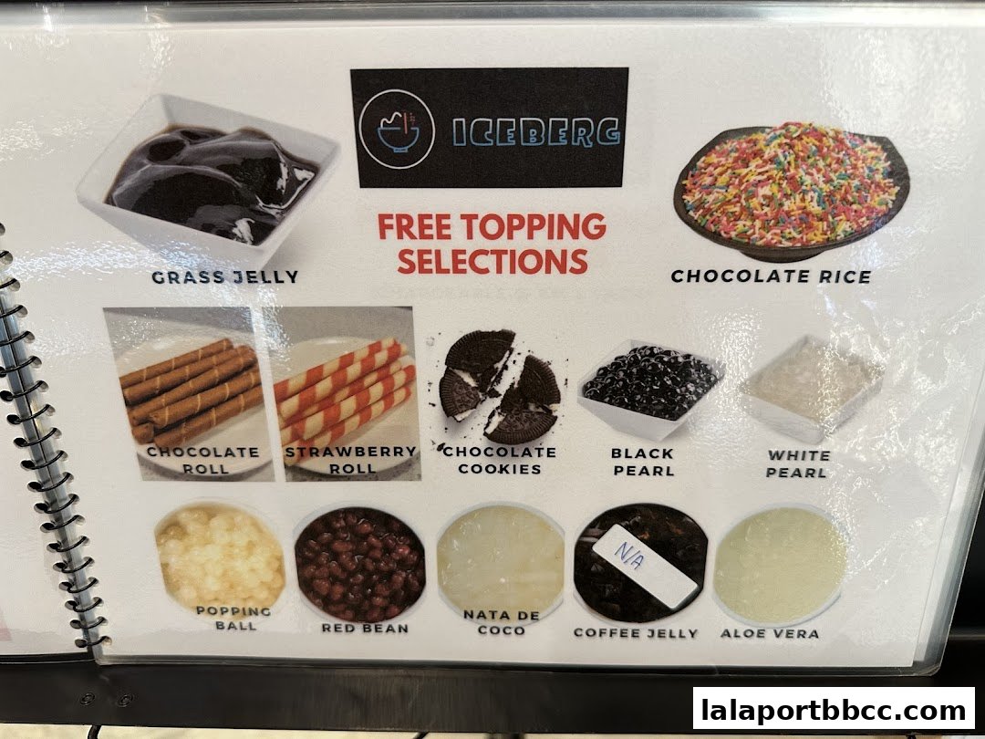 A menu showcasing various free topping selections for desserts at Iceberg LaLaport.