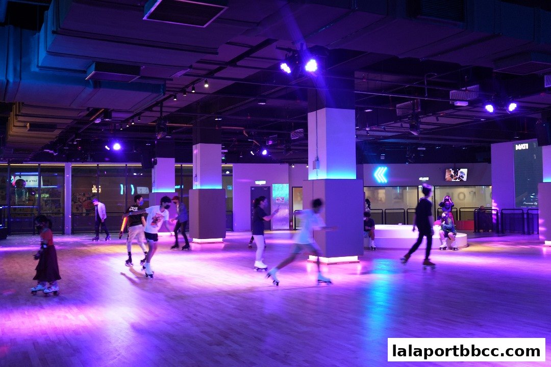 People roller skating in a dimly lit indoor rink with purple and blue lighting.
