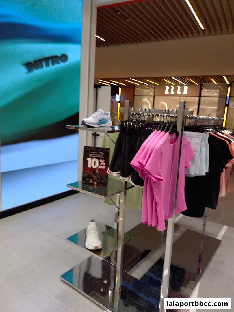 A display of athletic wear and shoes with a 10% off sale sign.