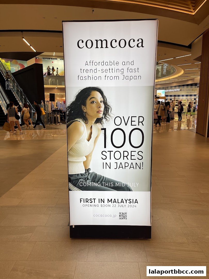 A banner announcing the opening of comcoca, a Japanese fashion brand, in Malaysia.
