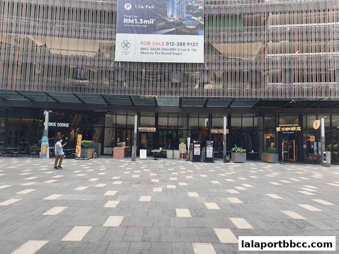 The exterior of the Eclipse Lalaport shop with adjacent businesses and a person walking.