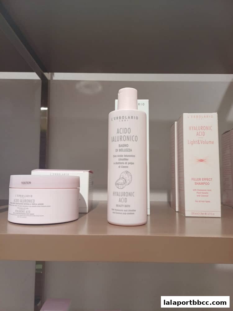 A shelf displaying various skincare products from L'Erbolario, including hyaluronic acid beauty bath and shampoo.