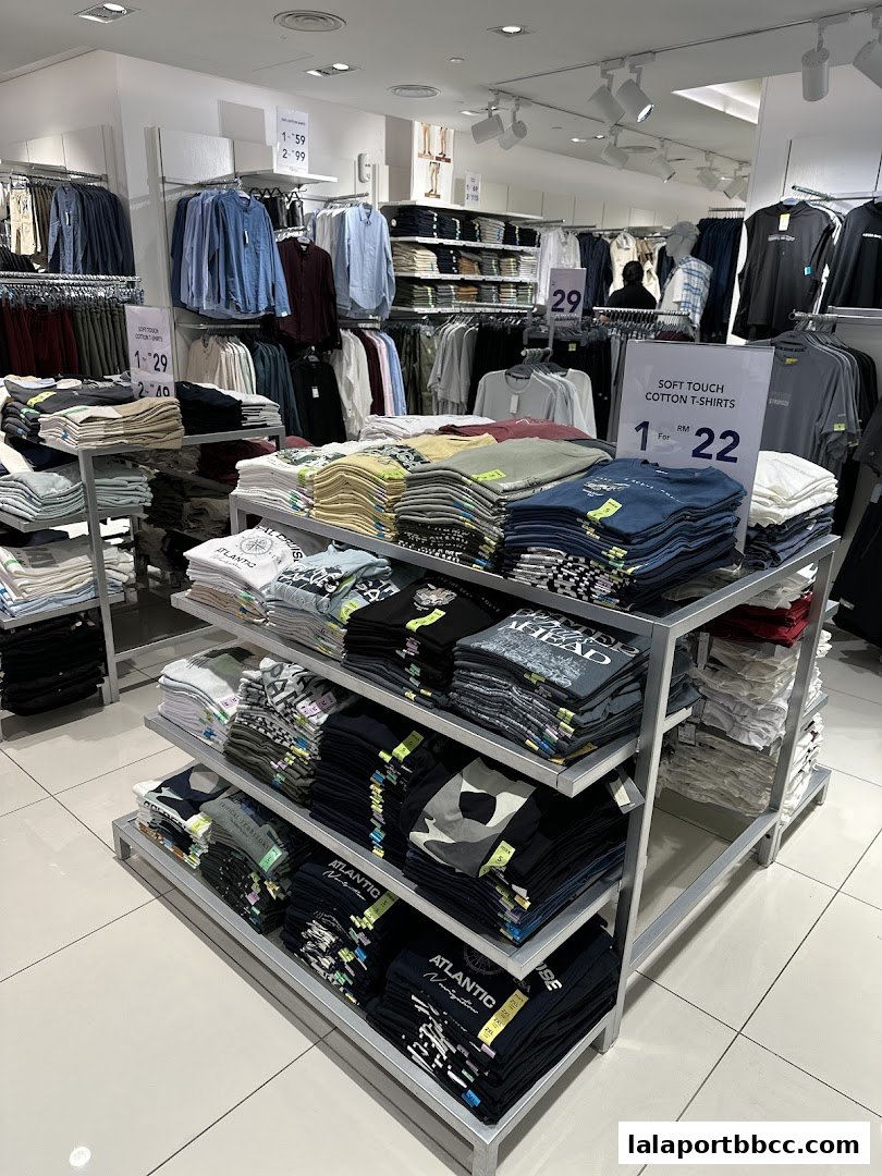 Interior view of a Max Fashion store showcasing neatly folded t-shirts and hanging apparel.