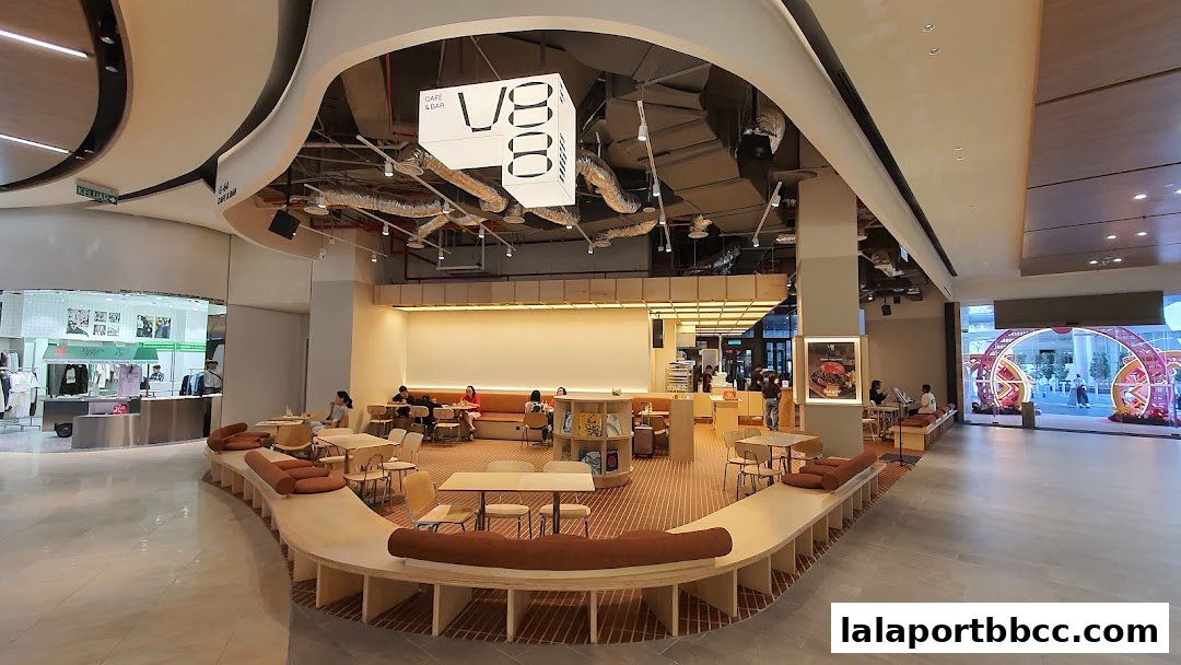 Interior of V88 Cafe and Bar with modern seating and a prominent V88 logo hanging from the ceiling.