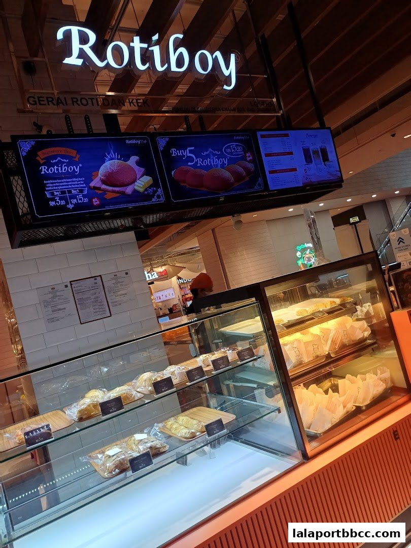 A display case filled with freshly baked buns and pastries at Rotiboy.