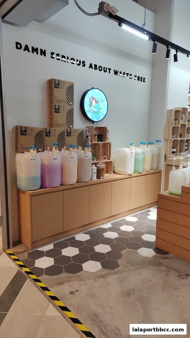 Interior of a store with large dispensers of liquids and shelves stocked with products.