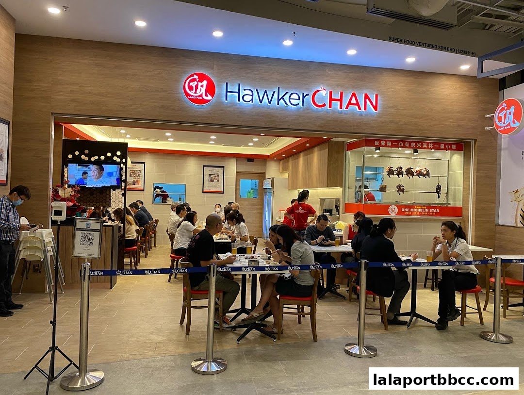 Interior view of Hawker Chan restaurant with customers dining and the restaurant signage visible.