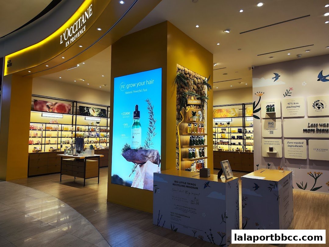 Interior of L'Occitane En Provence store showcasing products and a digital display.