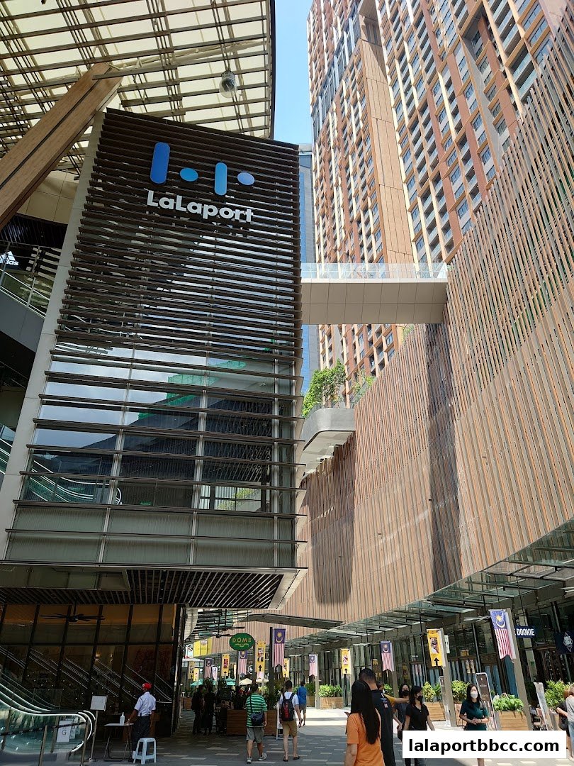 Exterior view of the LaLaport shopping mall with people walking along the covered walkway.