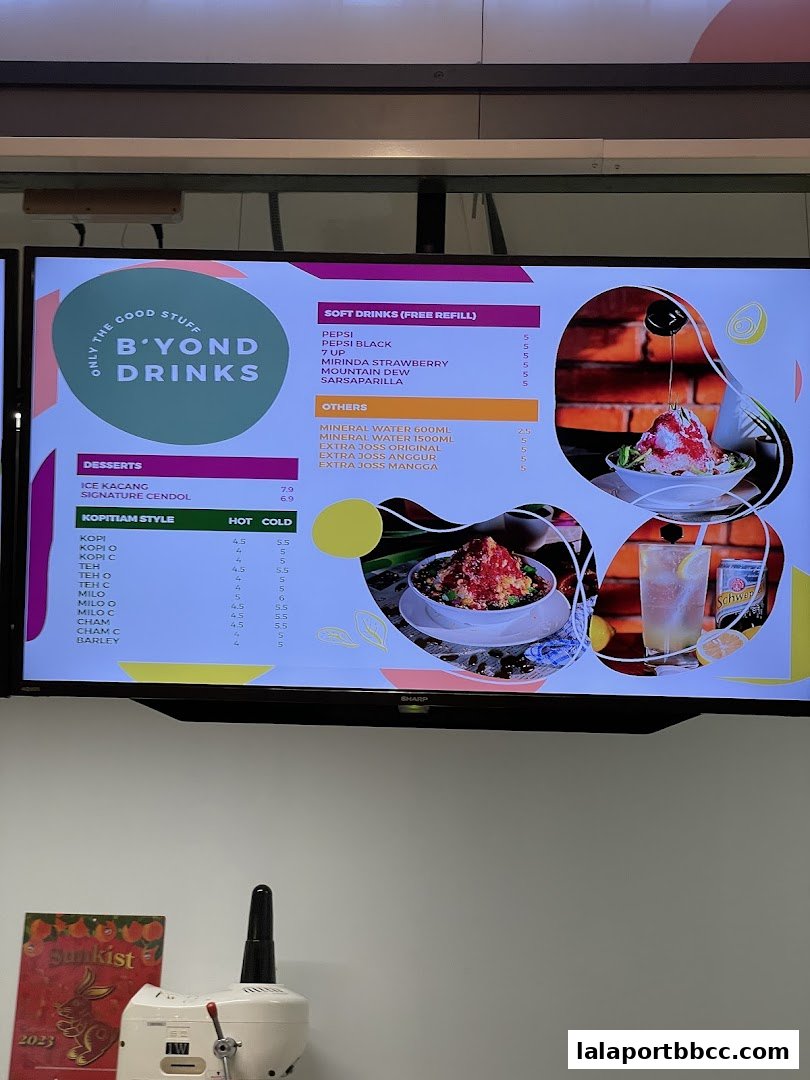 A digital menu board displaying drinks and desserts with prices.