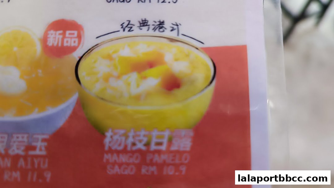 A close-up of a dessert menu featuring Mango Pomelo Sago and another dessert.