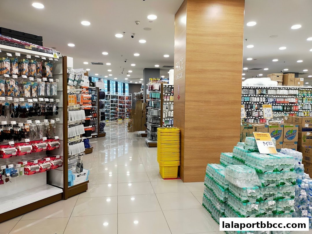 Interior view of a MR.DIY PLUS store showcasing aisles of products and stacked water bottles.