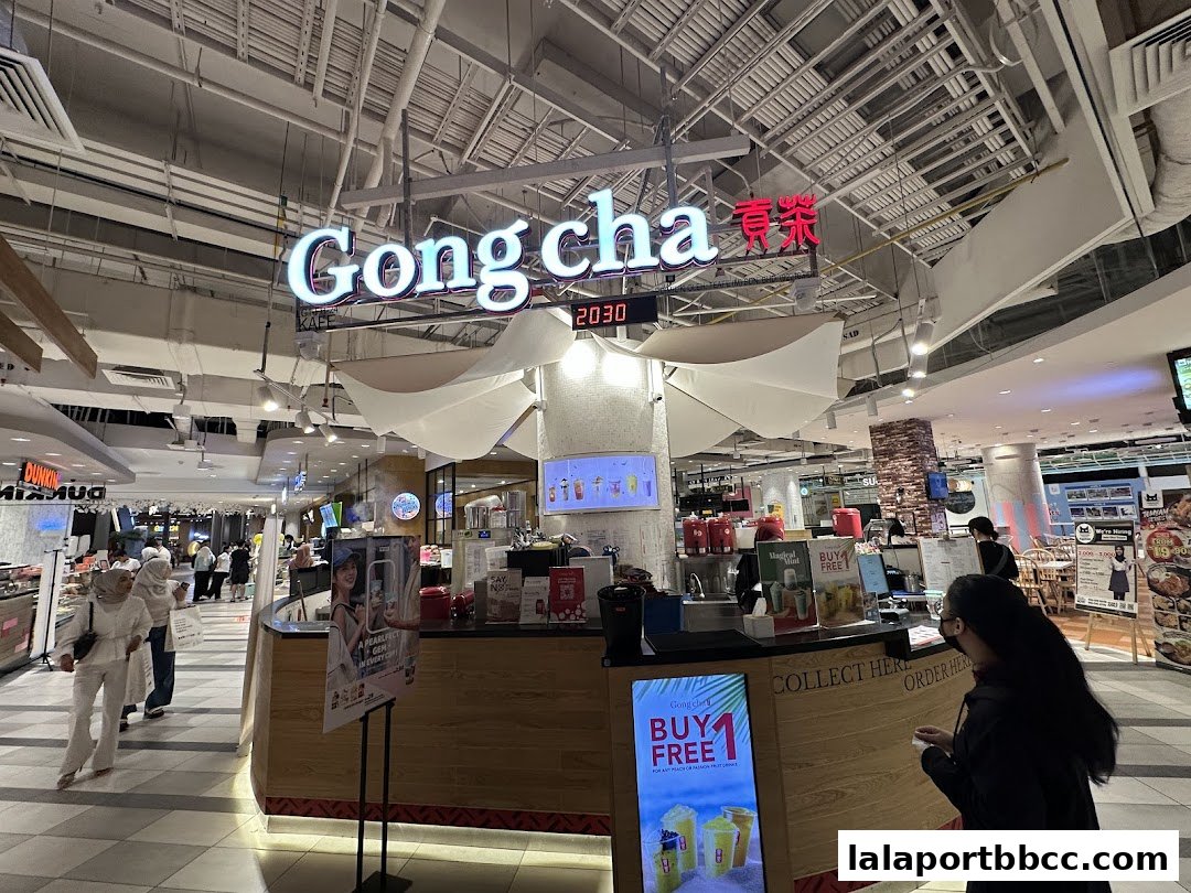 The Gong Cha bubble tea shop counter with a 'Buy 1 Free 1' promotion displayed.