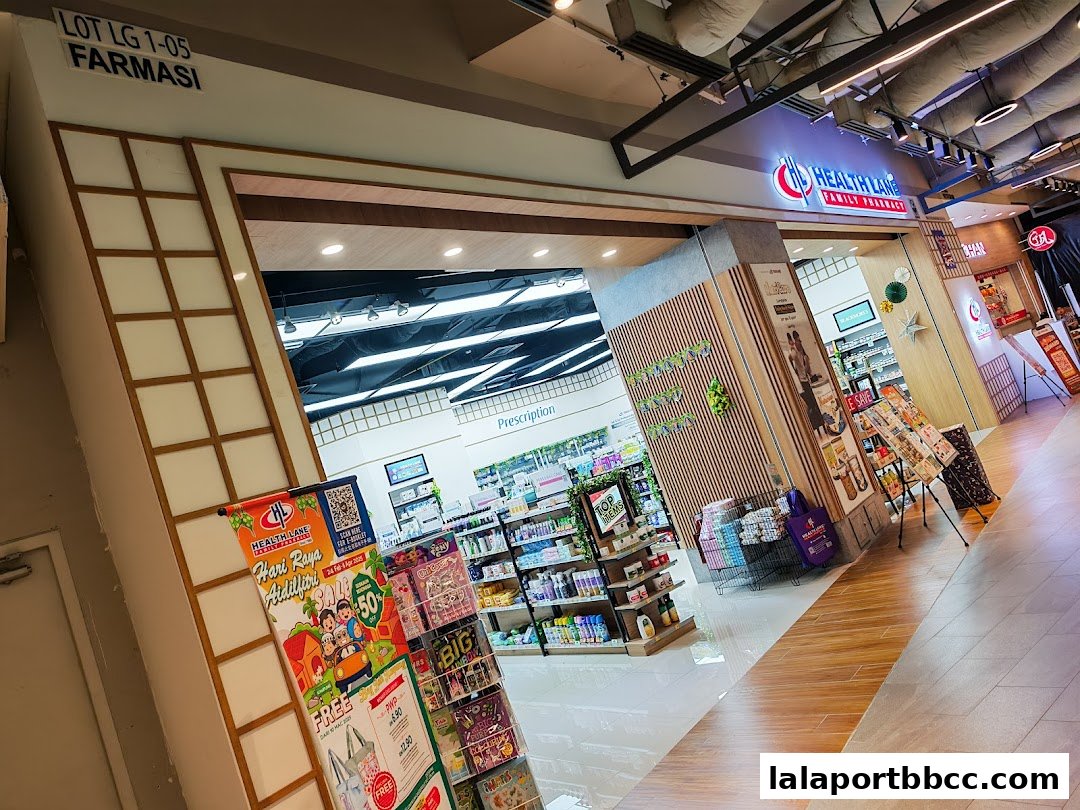 The entrance of Health Lane Family Pharmacy, showcasing products and promotional banners.