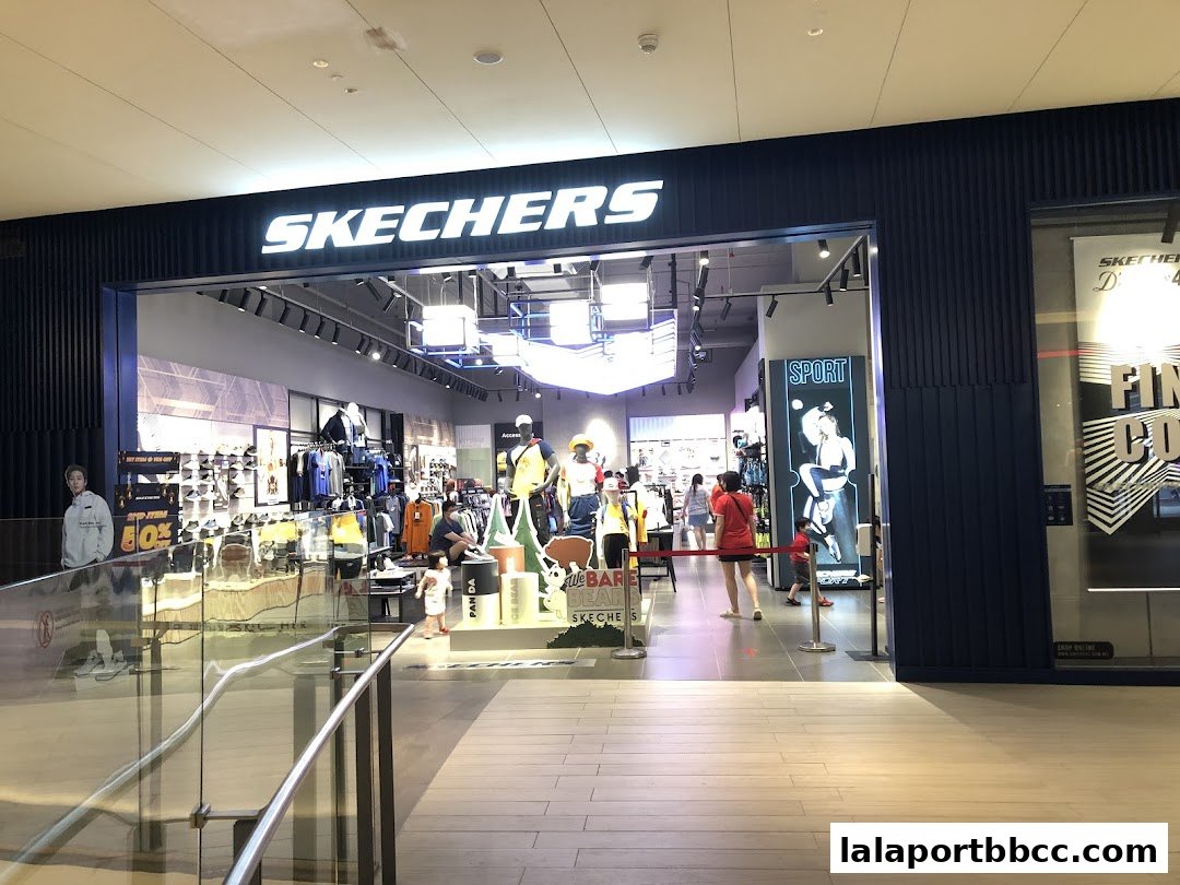 The entrance of a Skechers store with clothing and shoes displayed inside.