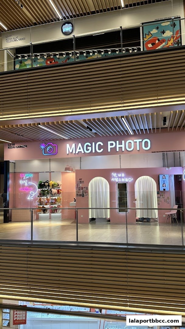 The Magic Photo shop front features a pink facade with neon signs and photo booths.