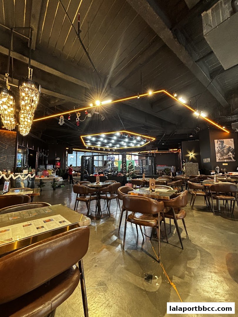 Interior of a restaurant with tables, chairs, and decorative lighting.