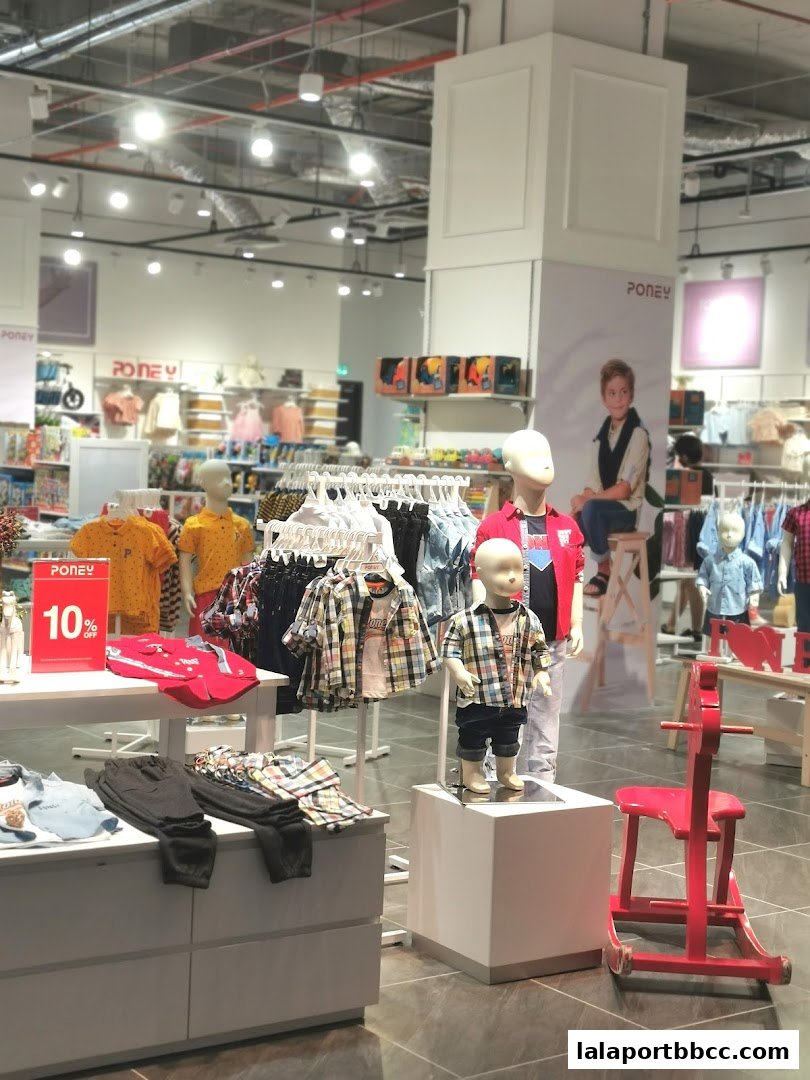 Interior view of a Poney children's clothing store with mannequins and merchandise.