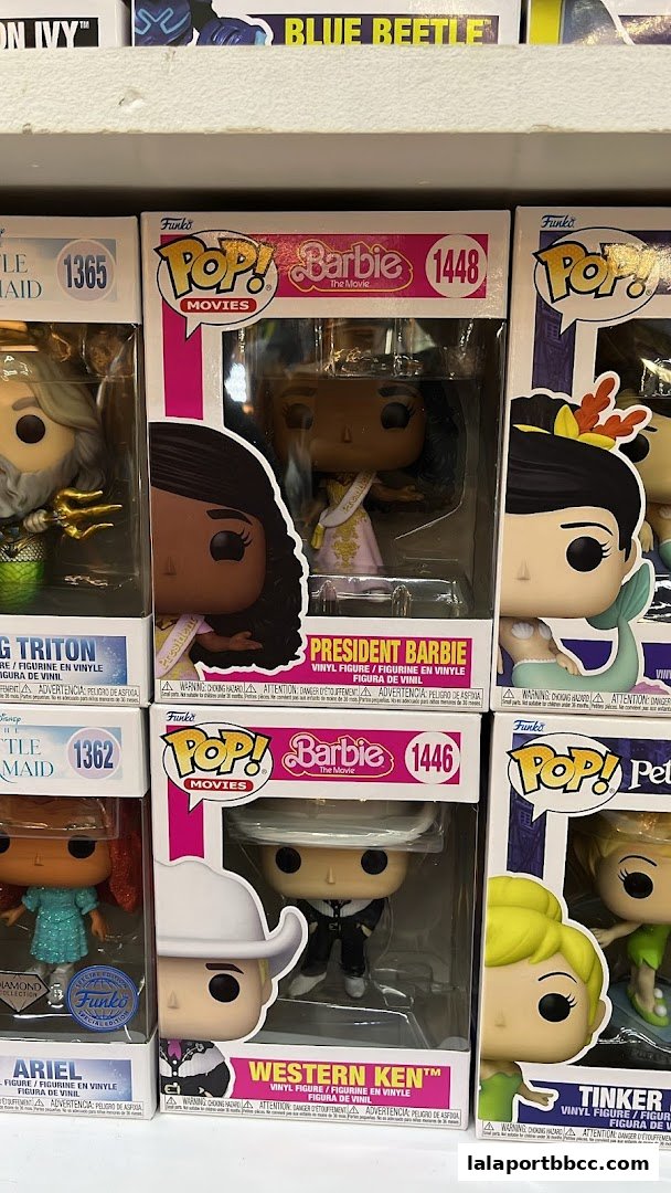 A collection of Funko Pop! vinyl figures from movies like Barbie and The Little Mermaid.
