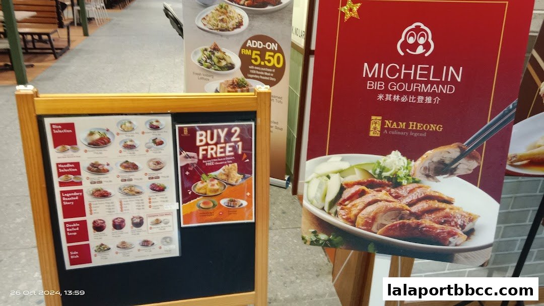 A menu board and a promotional poster for Nam Heong Chicken Rice, showcasing their Michelin Bib Gourmand status.
