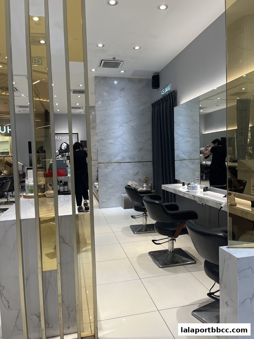 Interior view of a modern hair salon with styling chairs and mirrors.