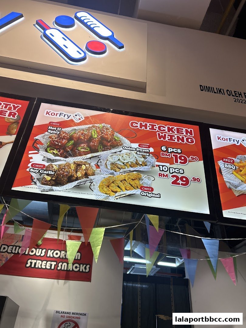 A brightly lit menu board showcasing KorFry's delicious chicken wings and Korean street snacks.