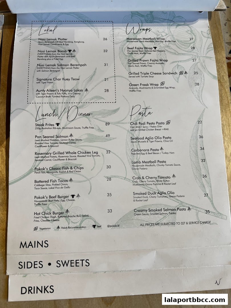 A menu from POKOK LaLaport featuring categories like Lokal, Wraps, Pasta, Mains, Sides, Sweets, and Drinks.
