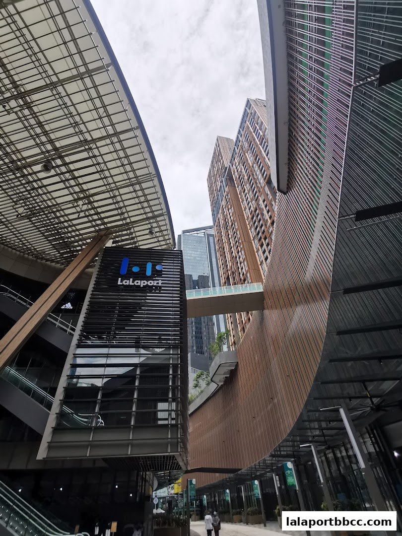 Modern architecture of a shopping mall with a prominent LaLaport sign and skybridge.